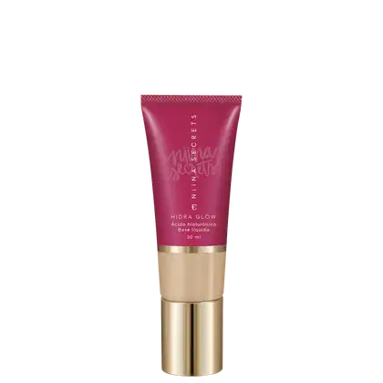 Tubo de base líquida Hidra Glow da marca Niina Secrets, com embalagem rosa e detalhes dourados, contendo 30 ml do produto.