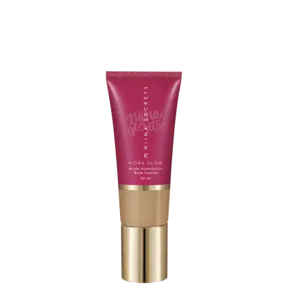 Tubo de base líquida Hidra Glow da marca Niina Secrets, com embalagem rosa e detalhes dourados, contendo 30 ml de produto.