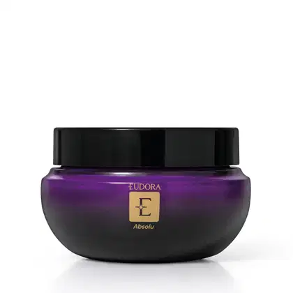 Frasco de item de cuidados corporais da marca Eudora, na cor roxa com tampa preta, com rótulo dourado contendo a palavra "Absolu".