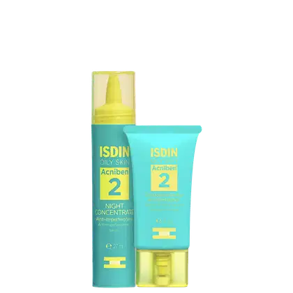 Produtos de cuidado para pele oleosa da marca ISDIN. Um frasco pequeno amarelo com tampa branca contendo um concentrado noturno anti-imperfeições. Um tubo azul com detalhes amarelos contendo um creme de controle de brilho e imperfeições da linha Acniben.