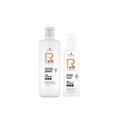 Dois frascos de produtos para cabelos da marca Schwarzkopf Professional: um frasco branco com rótulo laranja e outro frasco branco com rótulo branco e laranja, ambos com bombas doseadoras.