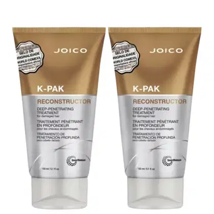 Dois tubos de tratamento capilar Joico K-Pak Reconstructor, com embalagem em tons de marrom e cinza, apresentando informações sobre o produto em diferentes idiomas.