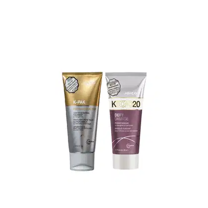 Dois produtos de tratamento capilar da marca Joico: um tubo dourado de K-PAK Reconstructor e um tubo roxo de Kbond 20 Defy Damage Power Masque, ambos com rótulos e embalagens característicos da marca.