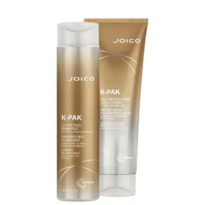 Conjunto de produtos Joico K-Pak, incluindo um frasco de shampoo clarificante e um tubo de condicionador reconstrutor, ambos com embalagens em tons de dourado e branco.