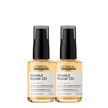 A imagem mostra dois frascos de óleo reparador Absolut Repair Oil da linha Serie Expert da L'Oréal Professionnel. Os frascos são de plástico laranja brilhante com tampas pretas de bomba.