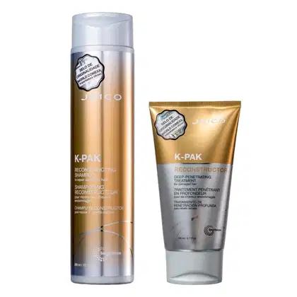 Dois produtos Joico K-Pak: um frasco de shampoo reconstrutor e um tubo de tratamento capilar reconstrutor de penetração profunda, ambos com embalagens prateadas e douradas.