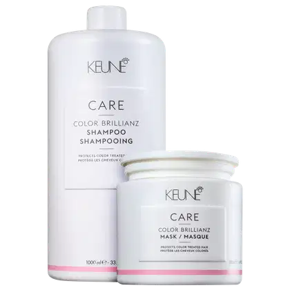 Dois produtos da marca Keune Care: um frasco de shampoo Color Brillianz e um pote de máscara Color Brillianz, ambos em embalagens brancas com detalhes em rosa, apresentando informações sobre a proteção da cor dos cabelos.