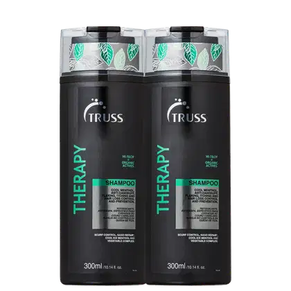 A imagem mostra dois frascos de shampoo da linha Therapy da Truss. Os frascos são pretos com detalhes em verde e branco, e têm folhas estampadas na parte superior transparente.
