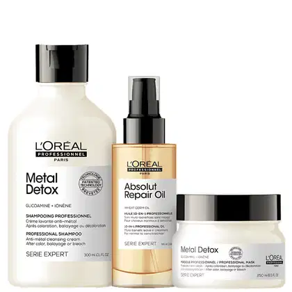 Conjunto de produtos L'Oréal Professionnel: shampoo Metal Detox, óleo reparador Absolut Repair Oil e máscara Metal Detox em embalagens brancas e pretas com detalhes em dourado.