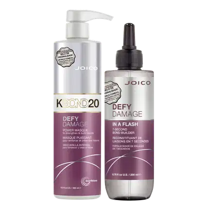 Dois produtos da marca Joico: um frasco de 500 ml da máscara capilar Defy Damage K-Bond 20 e um frasco de 200 ml do tratamento capilar Defy Damage In a Flash, ambos em embalagens brancas e roxas com detalhes em dourado.