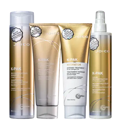 A imagem mostra quatro produtos de cuidados capilares da marca Joico, da linha K-Pak. Os produtos são: um shampoo reconstrutivo, um condicionador reconstrutivo, um tratamento intensivo e um reconstrutivo líquido em frasco spray transparente.