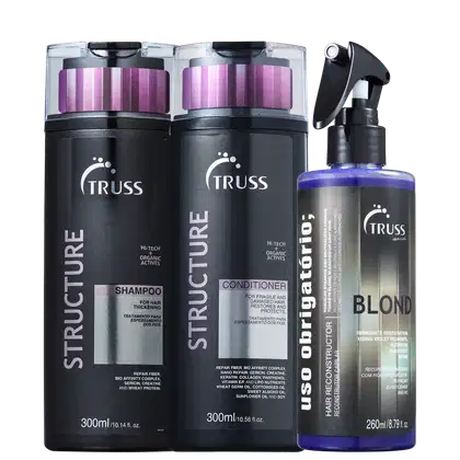 A imagem mostra um kit de produtos da marca TRUSS. Um shampoo e condicionador com frascos retangulares pretos e detalhes em roxo. Ao lado um frasco em spray do uso obrigatório blond.