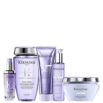 A coleção de produtos de beleza da marca Kérastase. Os rótulos exibem o nome da linha "Blond Absolu", indicando que esses produtos são voltados para cabelos loiros.