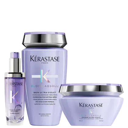 A imagem mostra três produtos da marca Kérastase Paris da linha Blond Absolu: shampoo, máscara e óleo capilar.