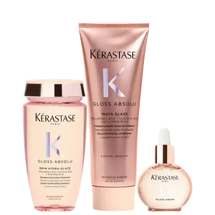 Três produtos da marca Kérastase: um frasco rosa de shampoo Gloss Absolu, um tubo rosa de condicionador Insta Glaze e um frasco de vidro com conta-gotas Glaze Drops, todos com design e rótulos da marca.