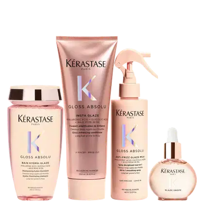 Produtos Kérastase em embalagens rosa e bege, incluindo shampoo, condicionador, spray e sérum para cabelos. As embalagens apresentam o logotipo da marca e informações sobre os benefícios dos produtos, como redução do frizz e brilho.