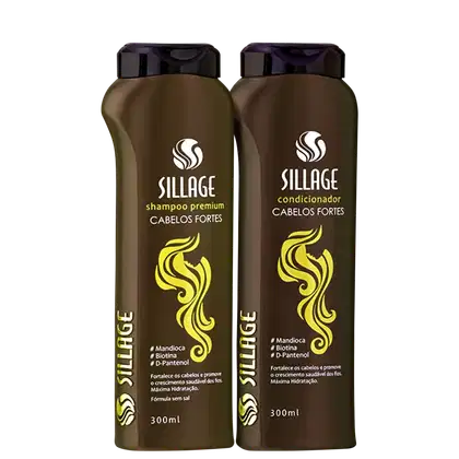 Dois frascos de produtos Sillage para cabelos fortes, um shampoo premium e um condicionador, em embalagens de 300ml com rótulos em cores marrom e amarelo destacando os ingredientes como mandioca, biotina e D-pantenol.