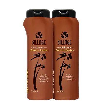 Dois frascos de shampoo e condicionador da marca Sillage, com embalagem de plástico marrom e rótulos com os dizeres "Coco e Jojoba". Os produtos apresentam hidratação máxima com óleo de coco, jojoba e D-pantenol.
