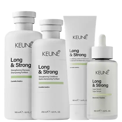 Produtos da linha Long & Strong da Keune, incluindo shampoo, condicionador, tratamento leave-in e sérum, em embalagens brancas com detalhes em verde, destacando ingredientes como Centella Asiática e peptídeos biomimétricos.
