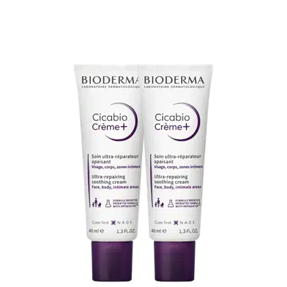 Dois tubos de creme Cicabio Creme+ da Bioderma, um produto de cuidado da pele com fórmula ultra-reparadora para rosto, corpo e áreas íntimas, em embalagens de 40 ml com rótulos em tons de roxo.