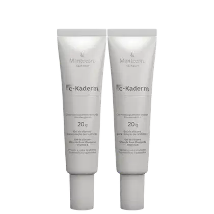 Dois tubos de gel de silicone da marca Mantecorp, chamado C-Kaderm, com 20g cada, para redução de cicatrizes. Embalagem branca com logotipo da marca e informações sobre o produto.
