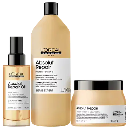 Produtos da linha Absolut Repair da L'Oréal Professionnel, incluindo um frasco de óleo, um frasco de shampoo e um pote de tratamento condicionante, todos em embalagens de design moderno e cores neutras.