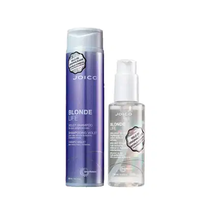 Produtos Joico Blonde Life: Shampoo violeta em frasco e óleo brilhante em embalagem plástica transparente. Embalagens com cores predominantes de roxo e branco, destacando o nome da linha "Blonde Life".