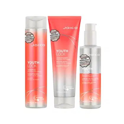 Conjunto de produtos Joico Youth Lock, incluindo shampoo, condicionador e creme para secagem, em embalagens com cores predominantes de laranja e branco, exibindo o selo de originalidade da marca.