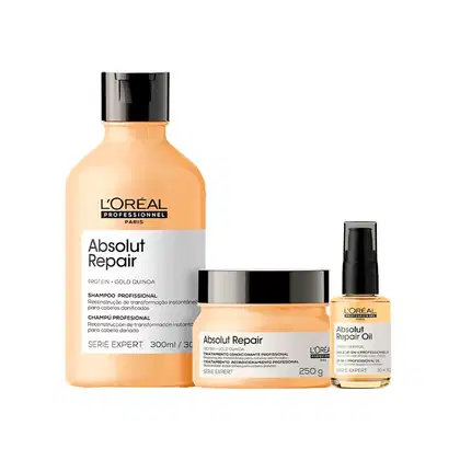 Linha de produtos Absolut Repair da L'Oréal Professionnel, incluindo shampoo, tratamento e óleo reparador, em embalagens com cores predominantes bege e preto.