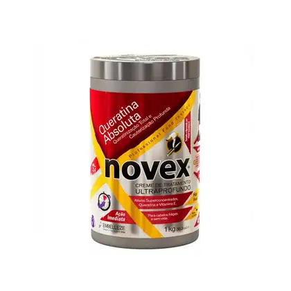 A imagem mostra o Creme de Tratamento Novex Queratina Absoluta 1kg da marca Embelleze. O pote é vermelho, amarelo e prateado. Traz a indicação para cauterização profunda de cabelos frágeis e sem vida.