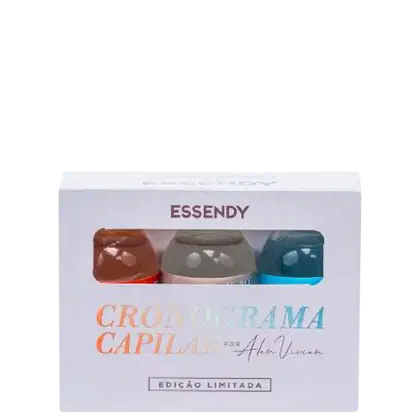 Caixa contendo três frascos de Cronograma Capilar da marca Essendy, uma linha de produtos para cuidados capilares. Cada frasco possui uma cor diferente - marrom, cinza e azul. Abaixo do nome do produto, há a assinatura "Por Alam Vieira".
