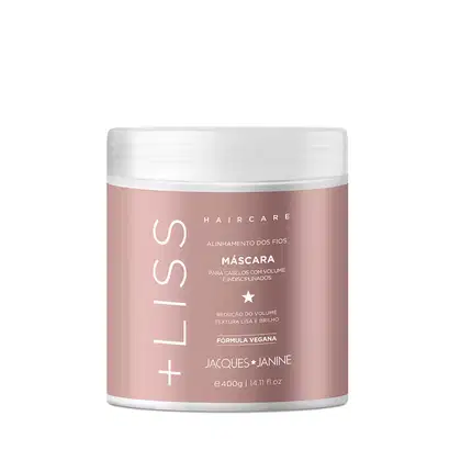 Embalagem de máscara capilar da linha Jacques Janine Professionnel, em recipiente branco com detalhes em rosa, indicando alinhamento dos fios e redução do volume, com fórmula vegana.