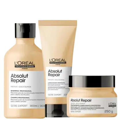 A imagem mostra um kit da linha Absolut Repair da L'Oréal Professionnel, com um frasco de shampoo, uma bisnaga de condicionador e um pote redondo de máscara, todos de cor bege com rótulo branco e tampa preta.