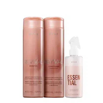 Dois frascos cilíndricos de plástico rosado contêm shampoo e condicionador da linha Revival, indicados para reconstrução imediata de cabelos extremamente danificados. Um spray capilar reparador chamado Essential, em um frasco plástico rosa.