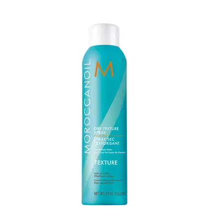 Frasco de spray Moroccanoil Dry Texture, com embalagem branca e azul turquesa, contendo 153g do produto. O rótulo apresenta o nome da marca e a descrição "Spray sec texturisant" em laranja.