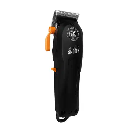 A imagem mostra uma máquina de corte preta com detalhes laranja. O corpo é cilíndrico com o logotipo "GBS Salon Exclusive" e a frase "Absolute Smooth" gravada. Possui uma lâmina de corte aparente na parte superior. O design é simples e moderno.