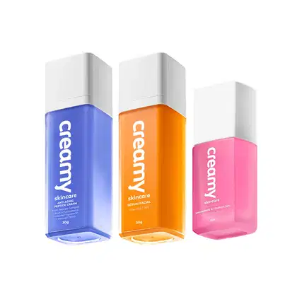 A imagem mostra três frascos retangulares transparentes de produtos cores azul, laranja e rosa, com tampas brancas.