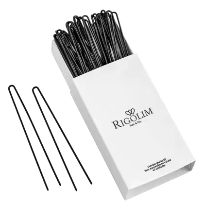 Grampos para cabelo da marca Rigolim Hair & Co. A embalagem é uma caixa branca com o logotipo e nome da marca impressos em preto. O conteúdo da caixa é um conjunto de grampos de cabelo pretos, que estão dispostos de forma organizada dentro da caixa.