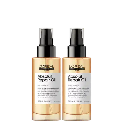 Dois frascos de óleo reparador Absolut Repair Oil da linha Serie Expert da L'Oréal Professionnel. Os frascos são de plástico transparente com tampa preta fosca. O rótulo indica que é um óleo de gérmen de trigo 10 em 1. O volume é de 90 ml