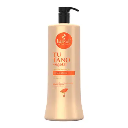 Condicionador Haskell. O frasco possui um rótulo circular laranja com o logotipo da marca Haskell. O produto é descrito como tendo "força e nutrição" e é indicado como sendo livre de parabenos e corantes, além de ser um produto vegano.
