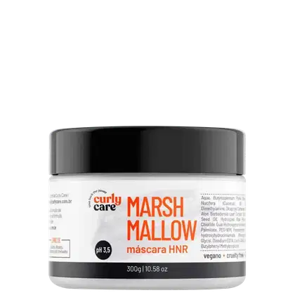 É um produto de tratamento capilar da marca Curly Care. A embalagem é um pote plástico branco com tampa preta. Na frente, há o nome do produto "MarshMallow" em letras grandes e laranjas, seguido de "máscara HNR" em letras menores.