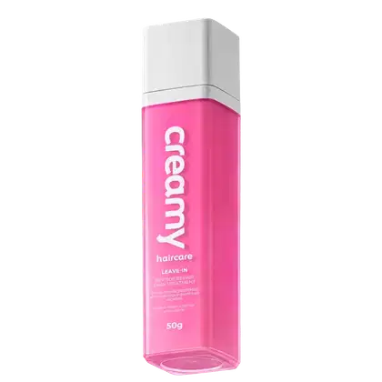 Frasco de tratamento capilar Creamy Haircare com 50g, em embalagem branca e rosa, com texto "Creamy haircare" e "Leave-in peptide repair hair treatment" visíveis.