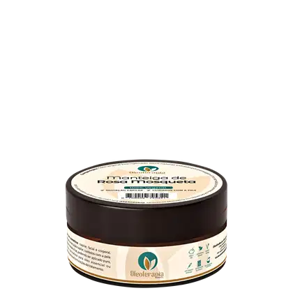 O produto apresentado é um pote de manteiga de rosa mosqueta da marca Oleoterapia Brasil. O pote é de cor marrom escuro, com um rótulo verde e branco que exibe o nome da marca e do produto.