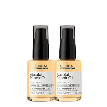 A imagem mostra dois frascos de óleo reparador Absolut Repair Oil da linha Serie Expert da L'Oréal Professionnel. Os frascos são de plástico laranja brilhante com tampas pretas de bomba.