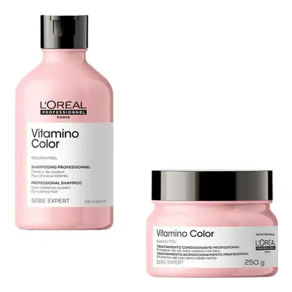 A imagem mostra dois produtos de cuidados capilares da linha Vitamino Color da L'Oréal Professionnel. Um é um shampoo em um frasco plástico rosa de 300ml e o outro é uma máscara capilar em um pote rosa de 250g.