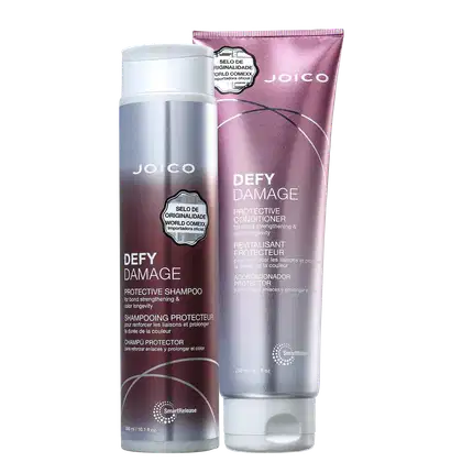 A imagem mostra dois produtos da linha "Defy Damage" da marca Joico: shampoo e condicionador. As embalagens são roxas com tons prateados e letras brancas.