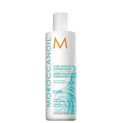 Frasco branco de condicionador Moroccanoil para realçar cachos, com rótulo em branco e laranja exibindo o nome da marca e a descrição "Curl Enhancing Conditioner".