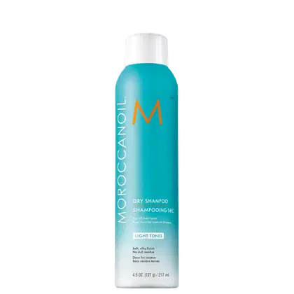 Frasco de shampoo seco Moroccanoil na cor azul-turquesa, com logotipo laranja e texto "Dry Shampoo" em destaque. Embalagem cilíndrica com tampa branca, indicando ser um produto para todos os tipos de cabelo.