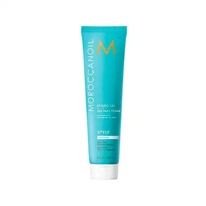 A imagem mostra o produto Moroccanoil Styling Gel 180ml, um tubo plástico cilíndrico de cor turquesa, com logotipo M em laranja e texto em branco e preto.