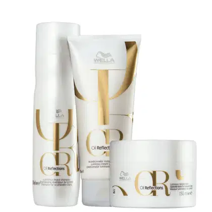 A imagem mostra 3 produtos de Wella Professionals Oil Reflections. Um frasco cilíndrico com shampoo, um tubular de condicionador e um pote redondo de máscara. Todos são brancos com detalhes dourados.